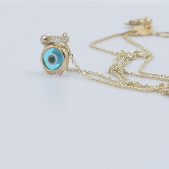 Murano glass evil eye necklace in 14k gold with cubic zirconia stones on the loop for women.