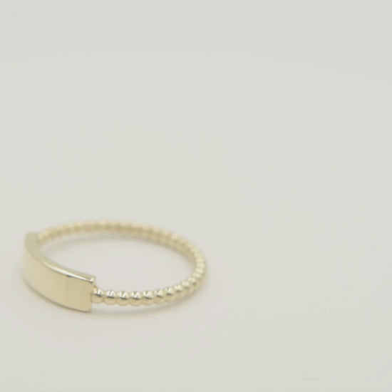 A personalized bar ring for women, crafted in 14k gold and featuring a beaded design.