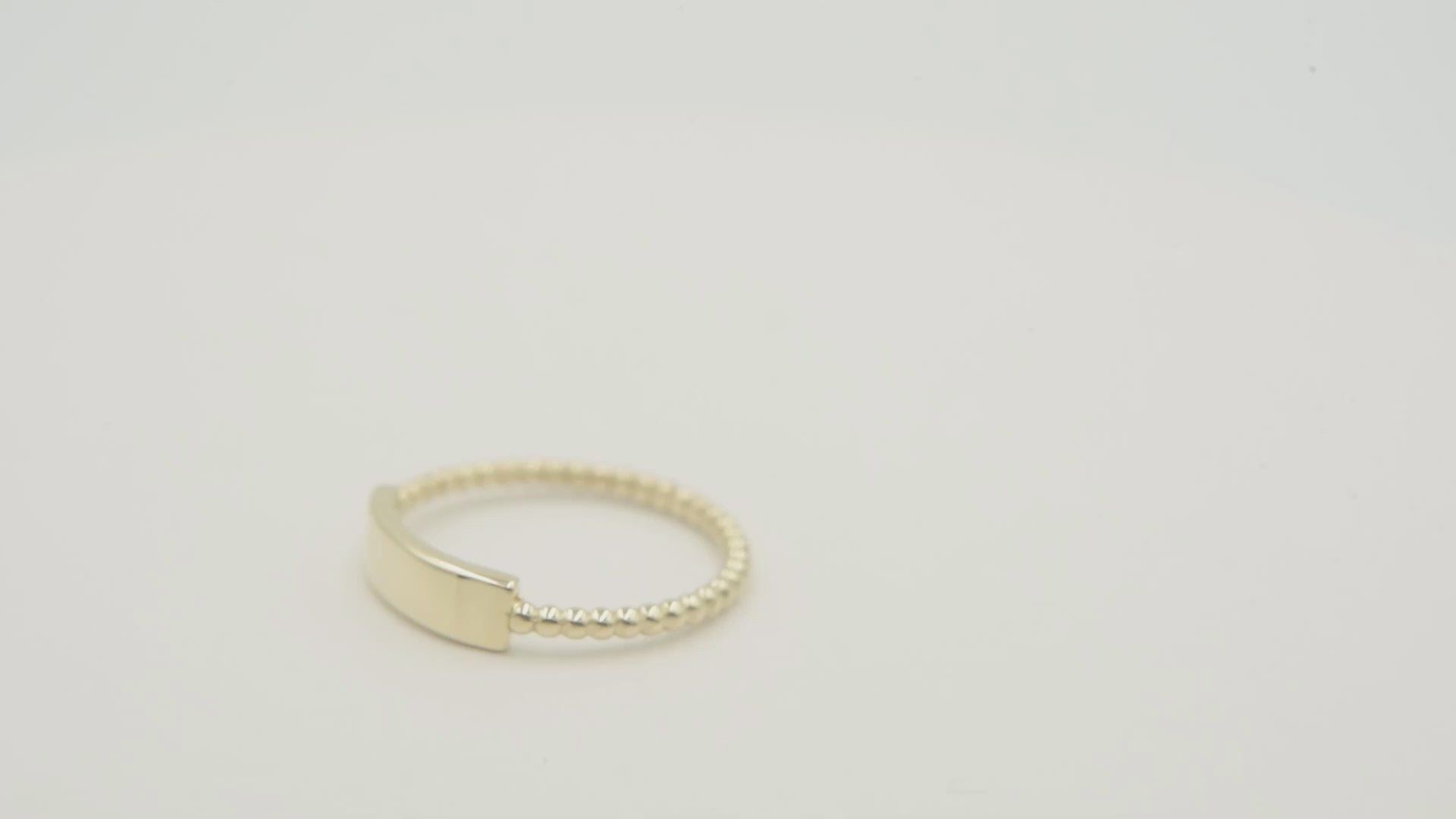 A personalized bar ring for women, crafted in 14k gold and featuring a beaded design.