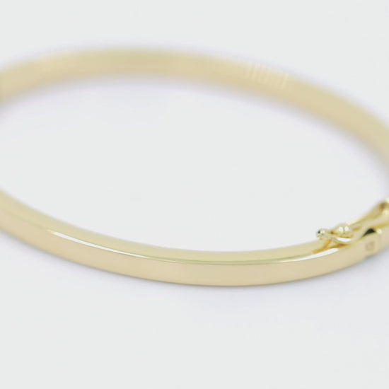 A 3.40mm hinged bangle bracelet in 14k gold, is an elegant choice for women.