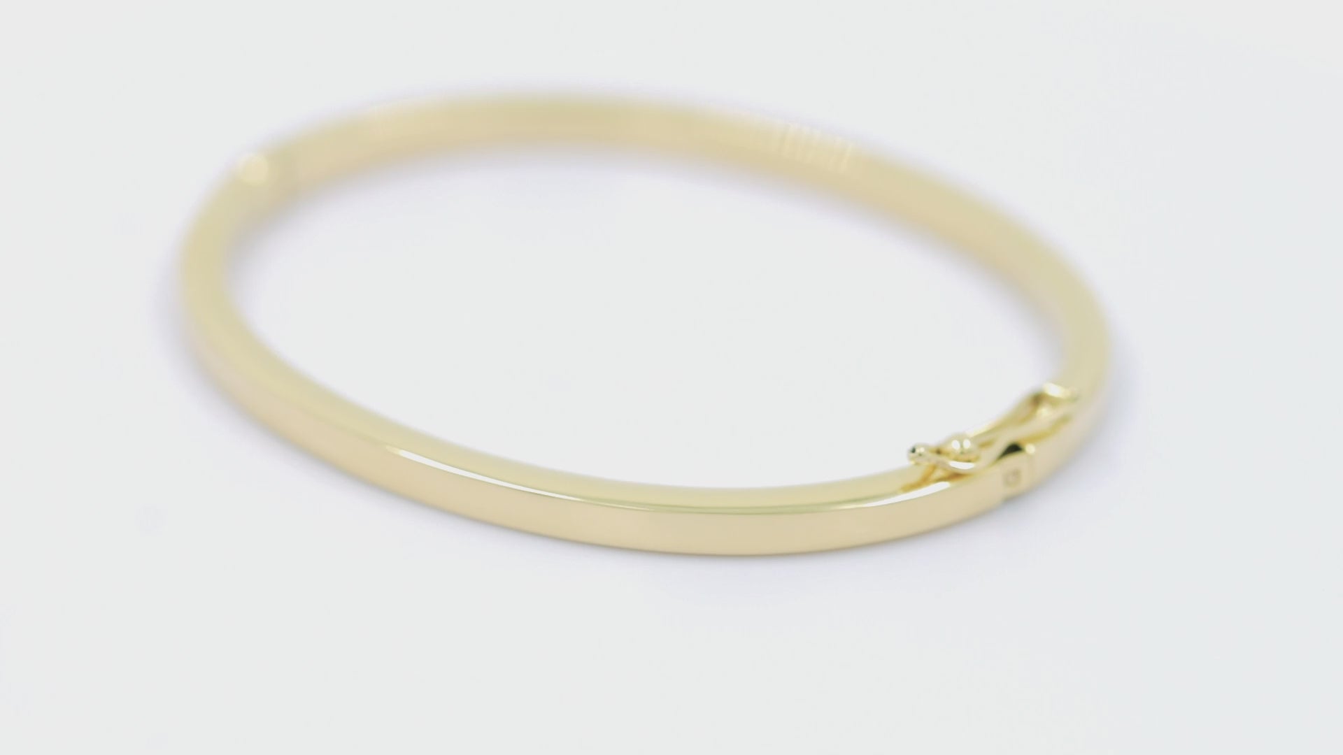 A 3.40mm hinged bangle bracelet in 14k gold, is an elegant choice for women.