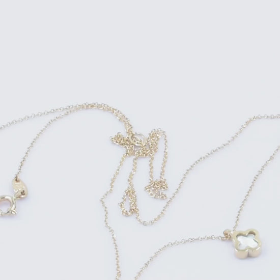 A 14k gold necklace for women, adorned with a clover-shaped mother of pearl motif.