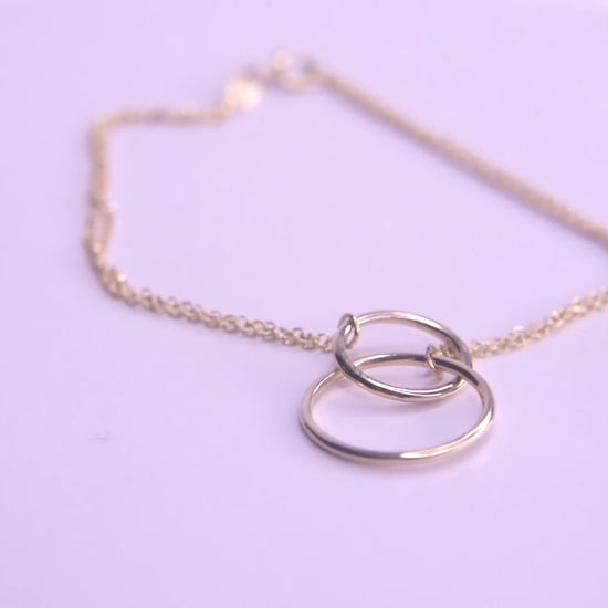 Interlocking bracelet crafted from 14k gold, featuring a double chain design.