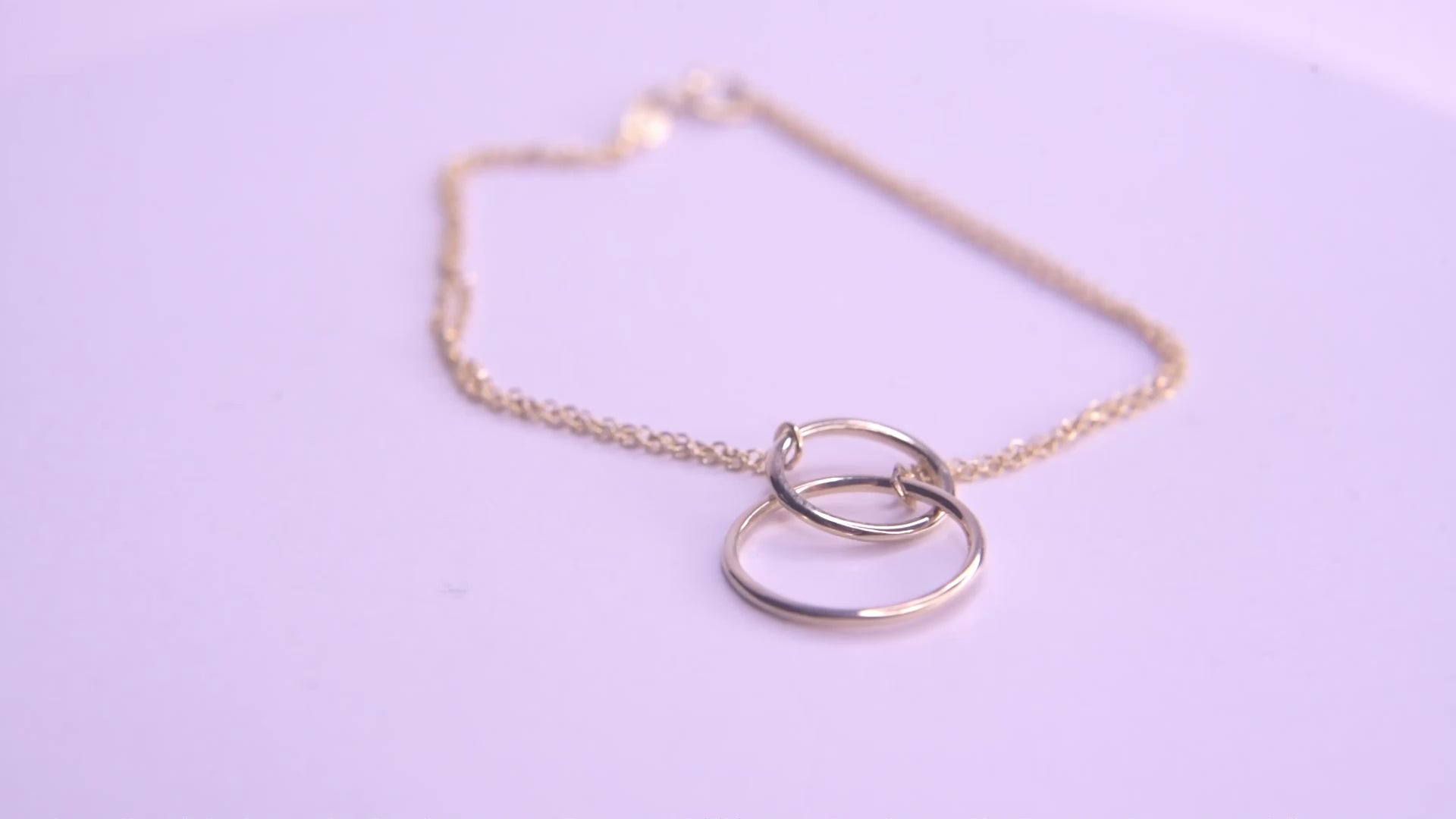 Interlocking bracelet crafted from 14k gold, featuring a double chain design.