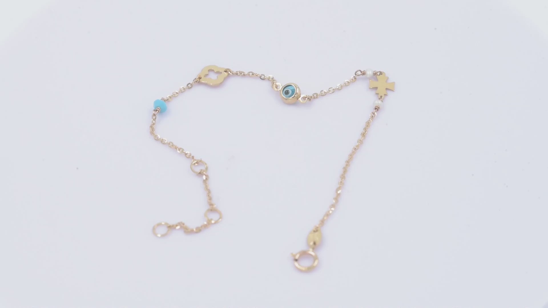 14k gold charm bracelet with evil eye, flower, cross, pearls, turquoise stone