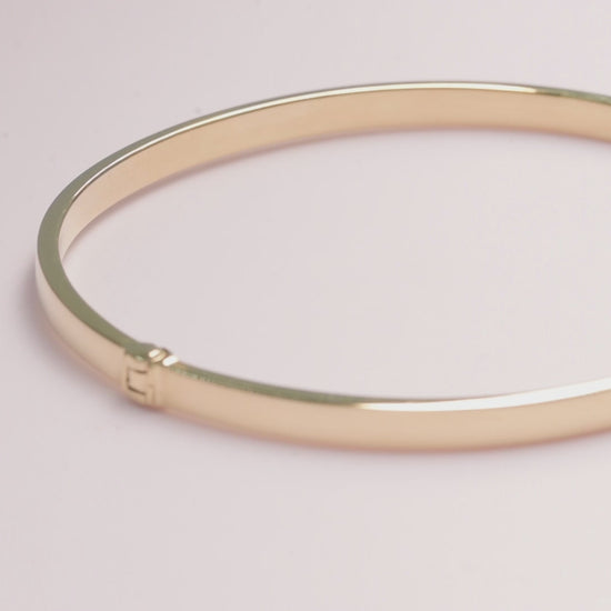 A 3.50mm bangle bracelet crafted in 14k yellow gold for 