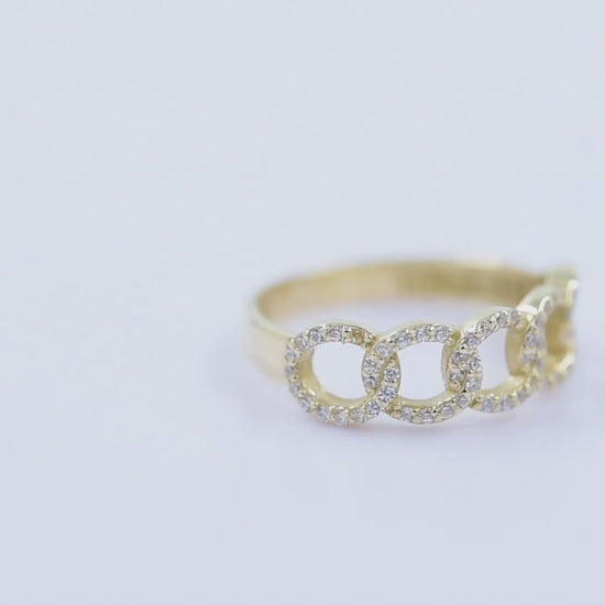 A handmade chain ring crafted in 14k solid gold, embellished with white cubic zirconia stones.