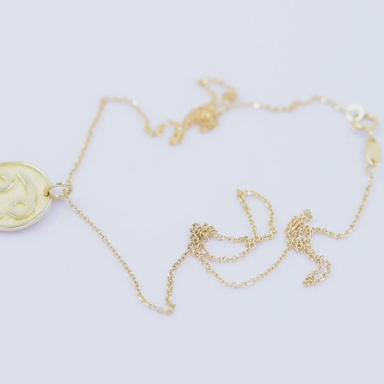 A Zodiac necklace for women, crafted in 14k gold, featuring complimentary engraving on the reverse side.