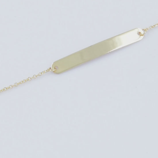 A delicate ID bracelet crafted in 14k gold, customizable for a personal touch.