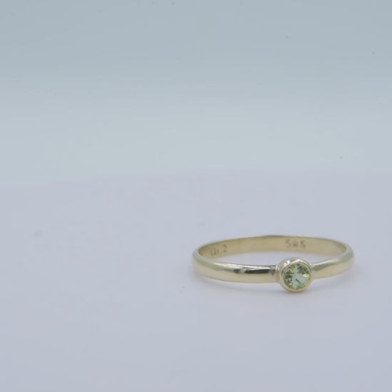 A handmade birthstone ring crafted in 14k solid gold, featuring a single stone in a bezel setting.