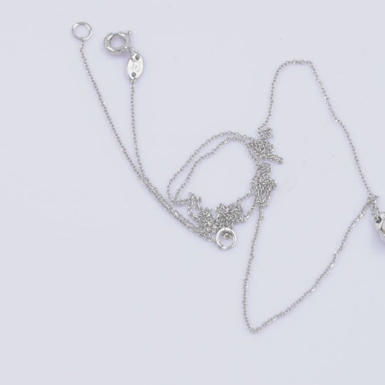 A diamond pearl necklace in 14k white gold for women.