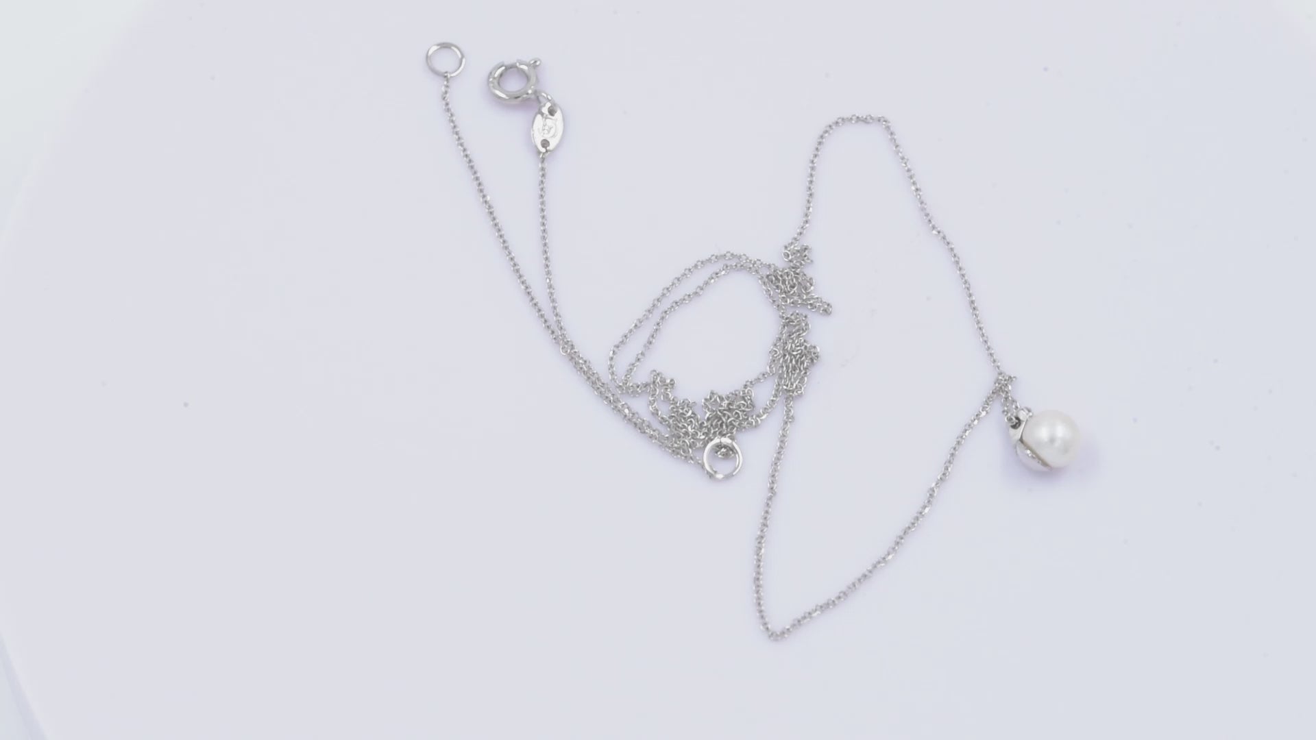 A diamond pearl necklace in 14k white gold for women.