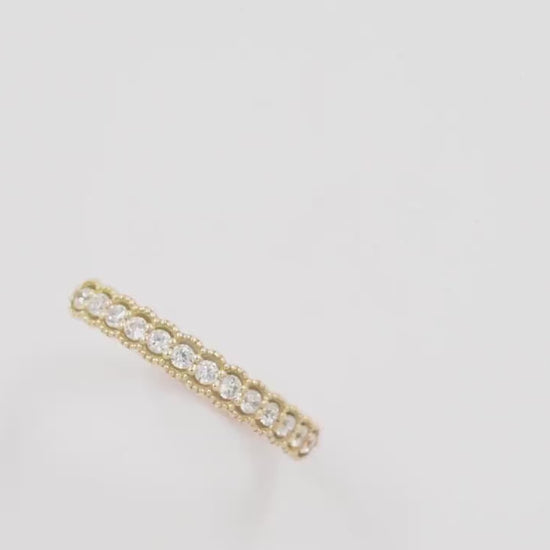 A women's half-eternity band ring featuring white cubic zirconia stones set in 14k gold.