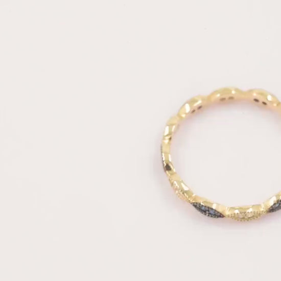 A full eternity band ring crafted in 14k gold, adorned with white and blue cubic zirconia stones.