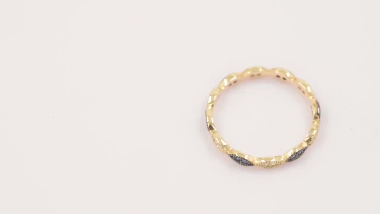 A full eternity band ring crafted in 14k gold, adorned with white and blue cubic zirconia stones.