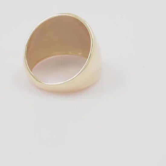 A large dome-shaped signet ring for women, crafted in 14k gold.