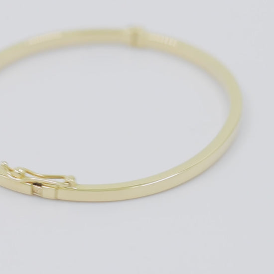 A 2.50mm bangle bracelet crafted in 14k gold, designed for women. 