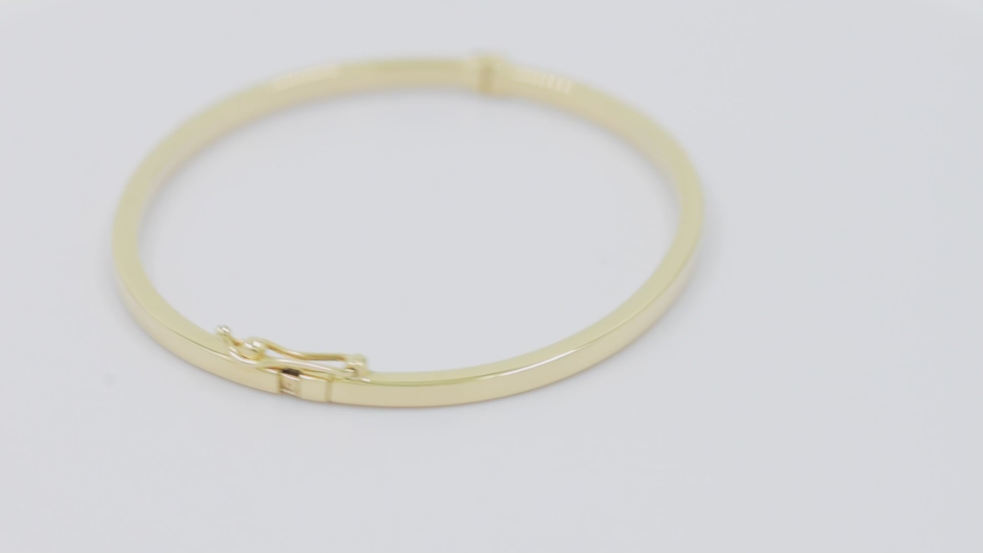 A 2.50mm bangle bracelet crafted in 14k gold, designed for women. 