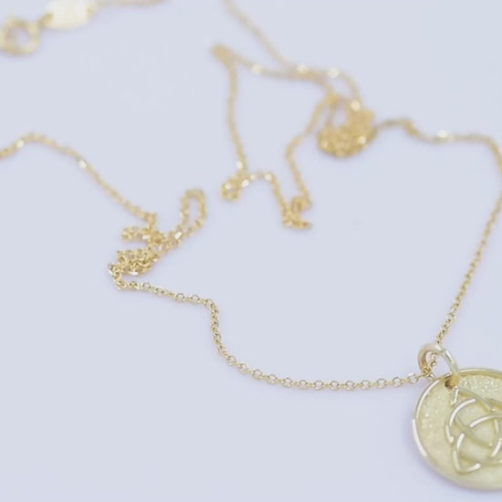 Trinity Knot Necklace in 14k solid gold for women, with complimentary engraving on the reverse side.