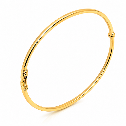 dainty 14k yellow Gold bangle on a white background