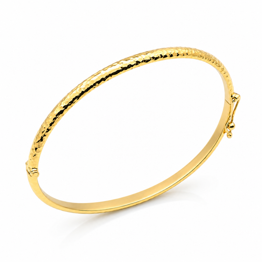 14k Gold hammered bangle on a white background