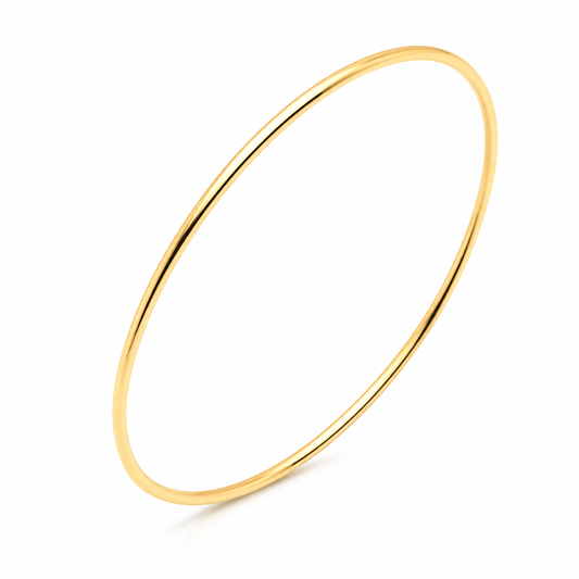 Slip on 14k Gold bangle on a white background