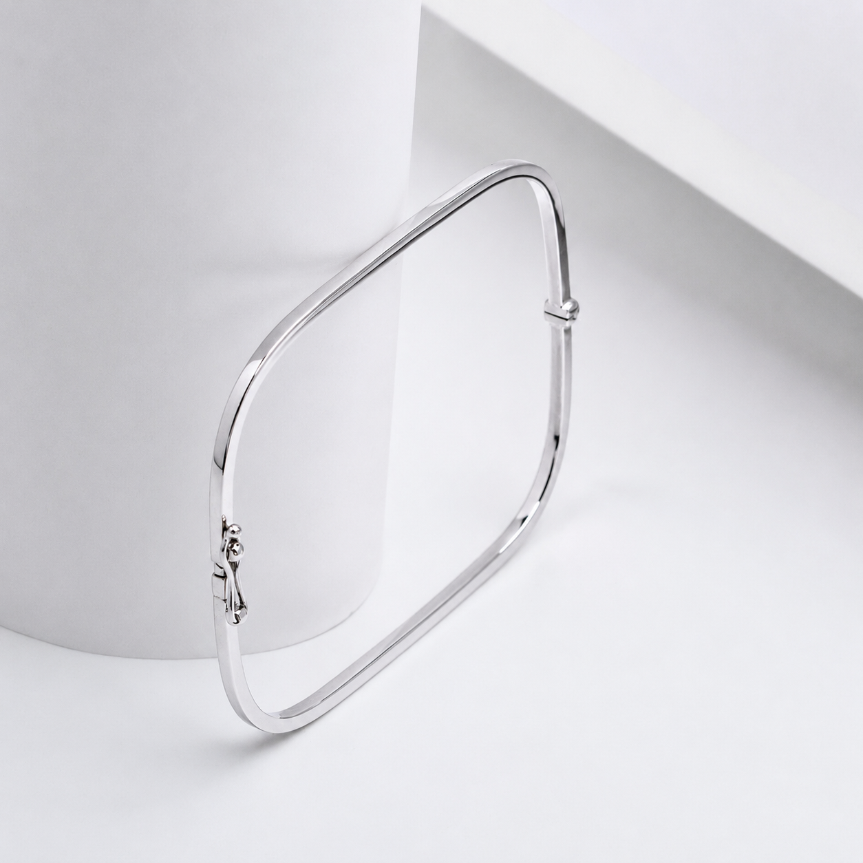 square 14k white gold bangle bracelet on a white backgound 