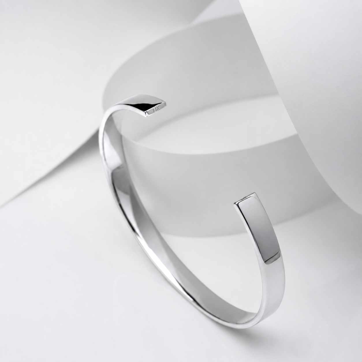 14k white Gold bangle on a white background