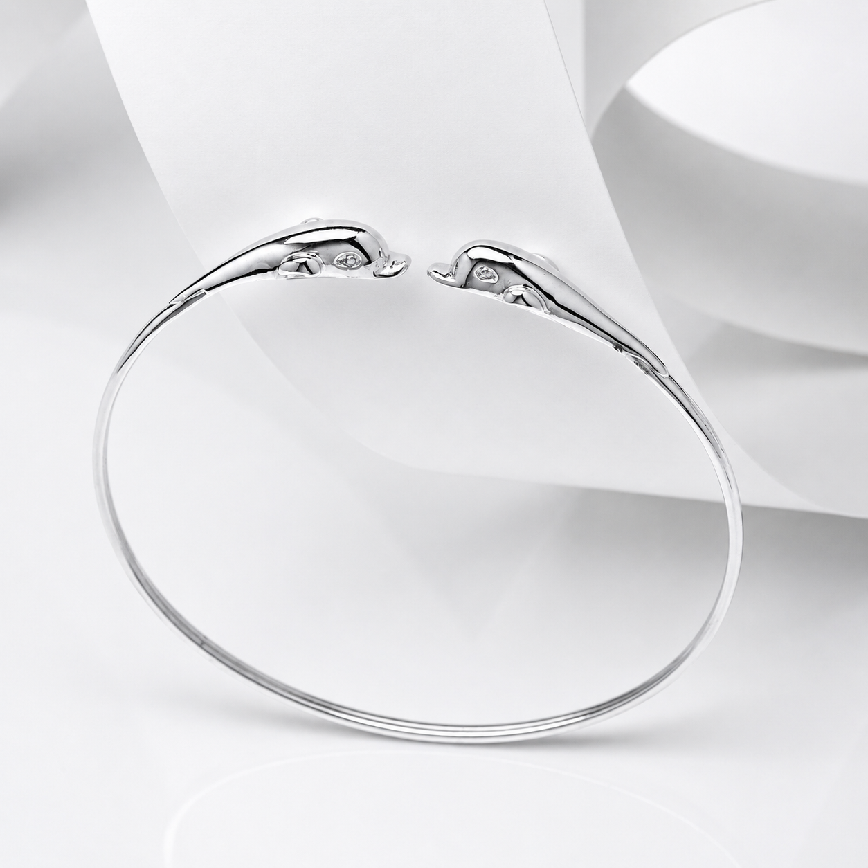 14k gold dolphin bangle bracelet in a white backgound 