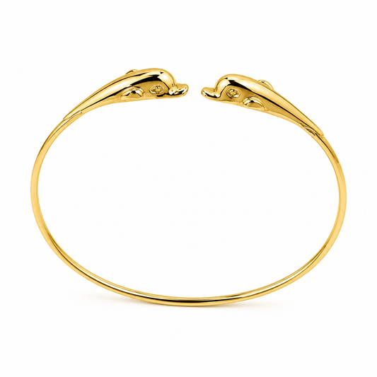 14k gold dolphin bangle bracelet in a white backgound 