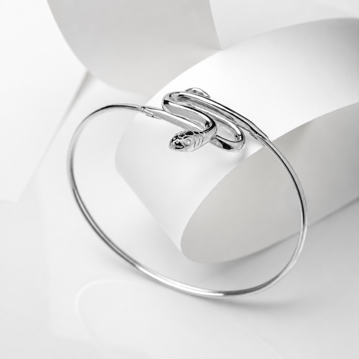 14k white gold bangle bracelet with a snake design on a white background