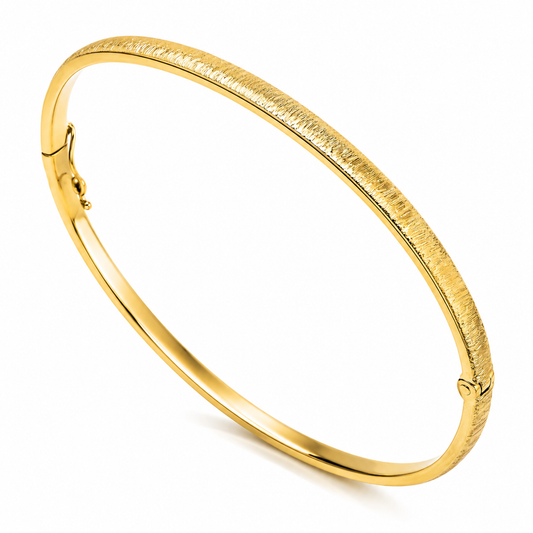 14k Gold sandbalsted bangle on a white background
