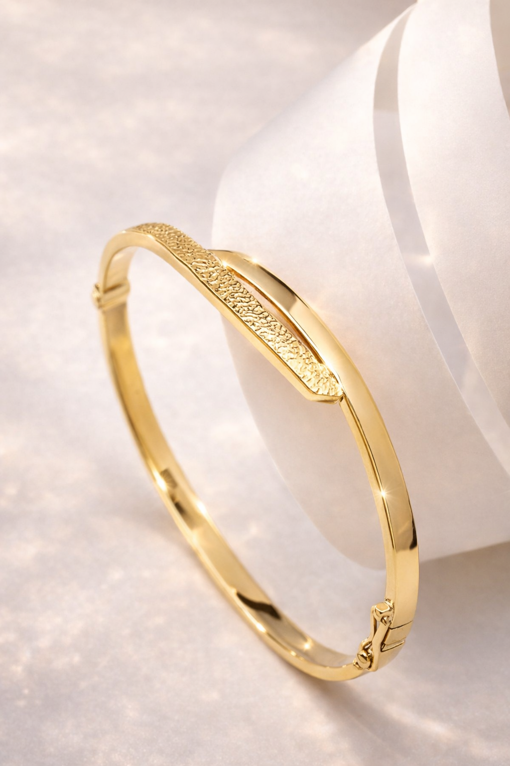 baypass 14k Gold bangle on a white background