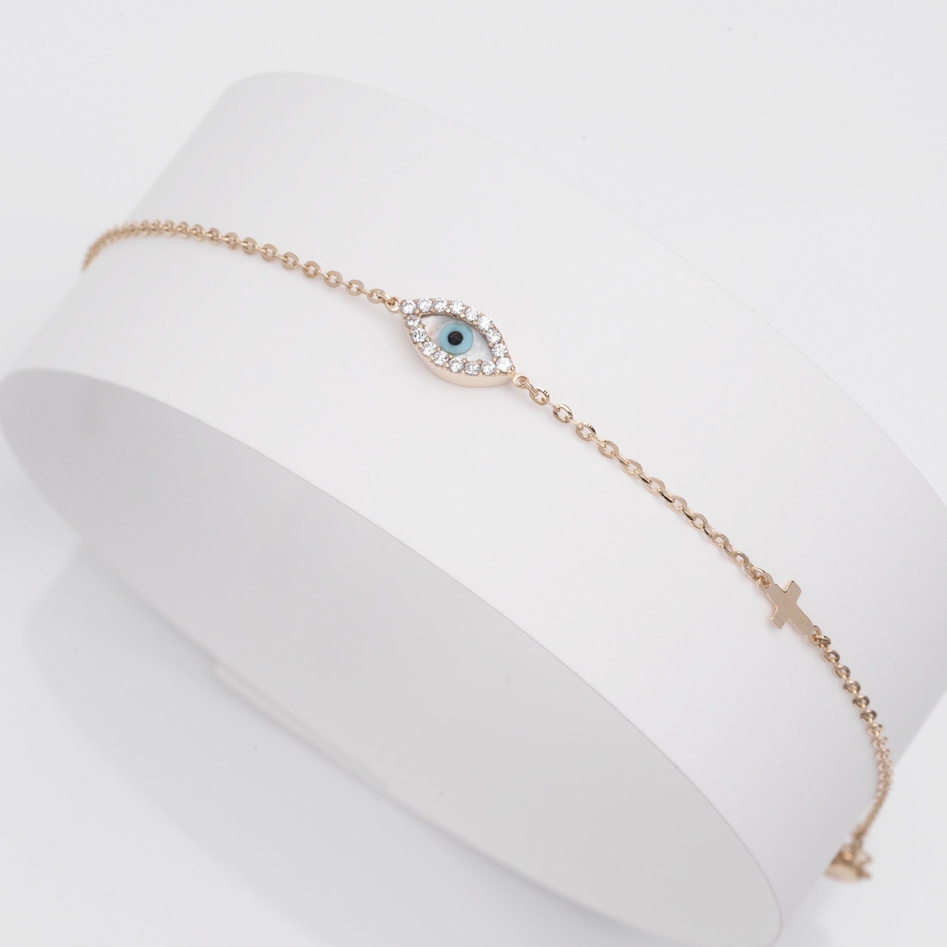 oval evil eye bracelet with cubic zirconia stones and small cross