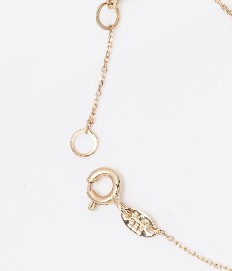 a spring ring bracelet clasp with an extender with two links in 14k yellow gold