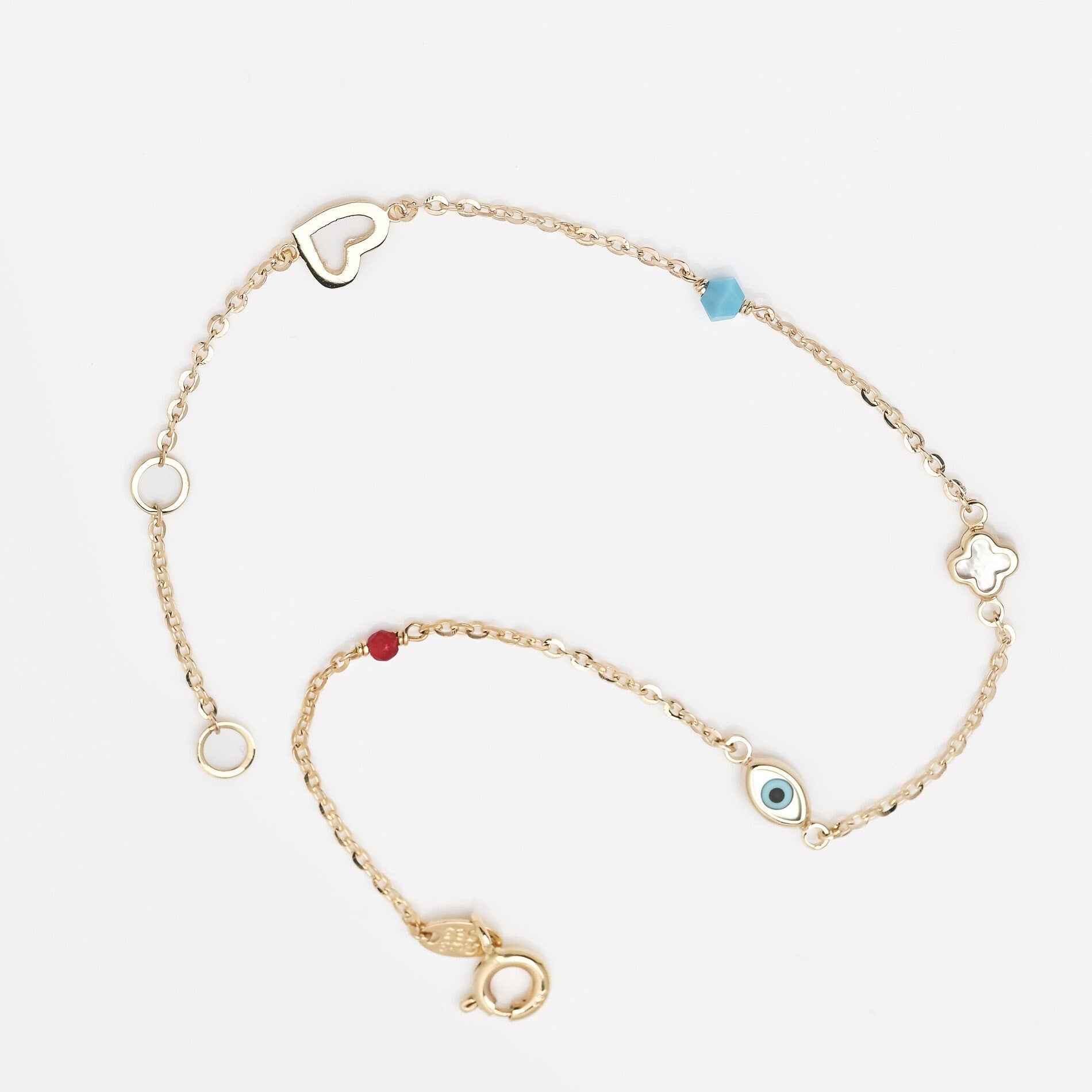 14k gold charm bracelet with afour leaf clover,heart,evil eye, turquoise and tourmaline stone