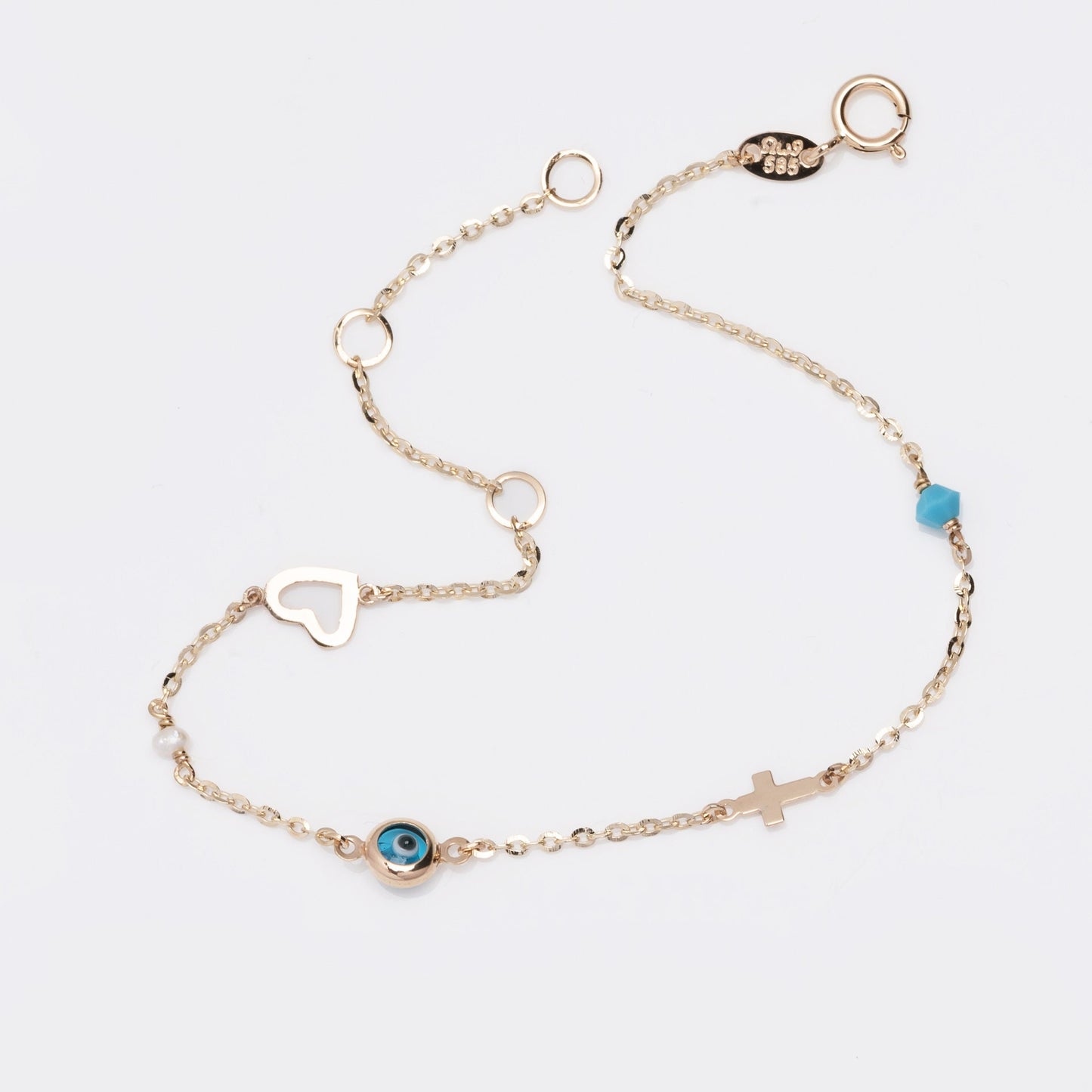 evil eye bracelet with cross, heart, pearl, turqoise stone in 14k solid gold