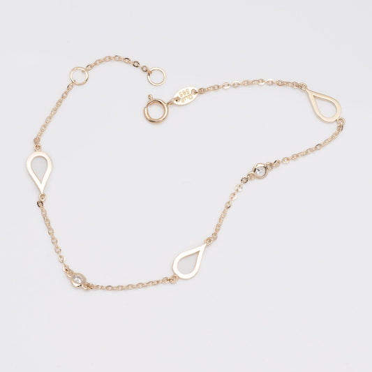 A 14k solid gold bracelet featuring droplets and cubic zirconia stones set in 14k gold.