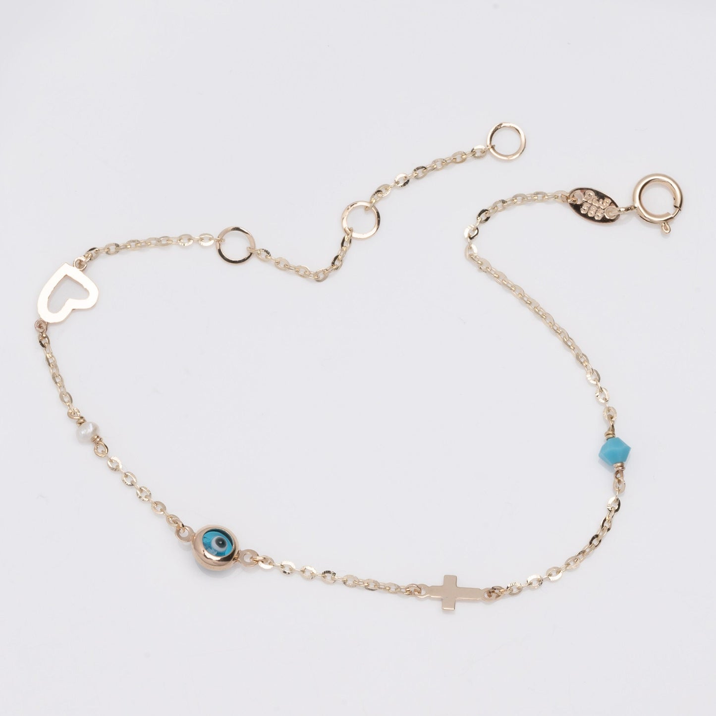 evil eye bracelet with cross, heart, pearl, turqoise stone in 14k solid gold