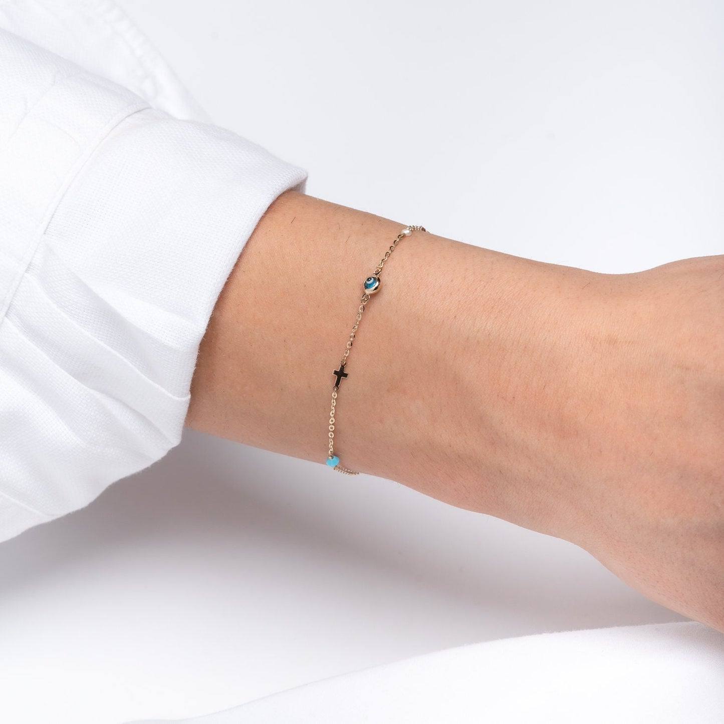 evil eye bracelet with cross, heart, pearl, turqoise stone in 14k solid gold