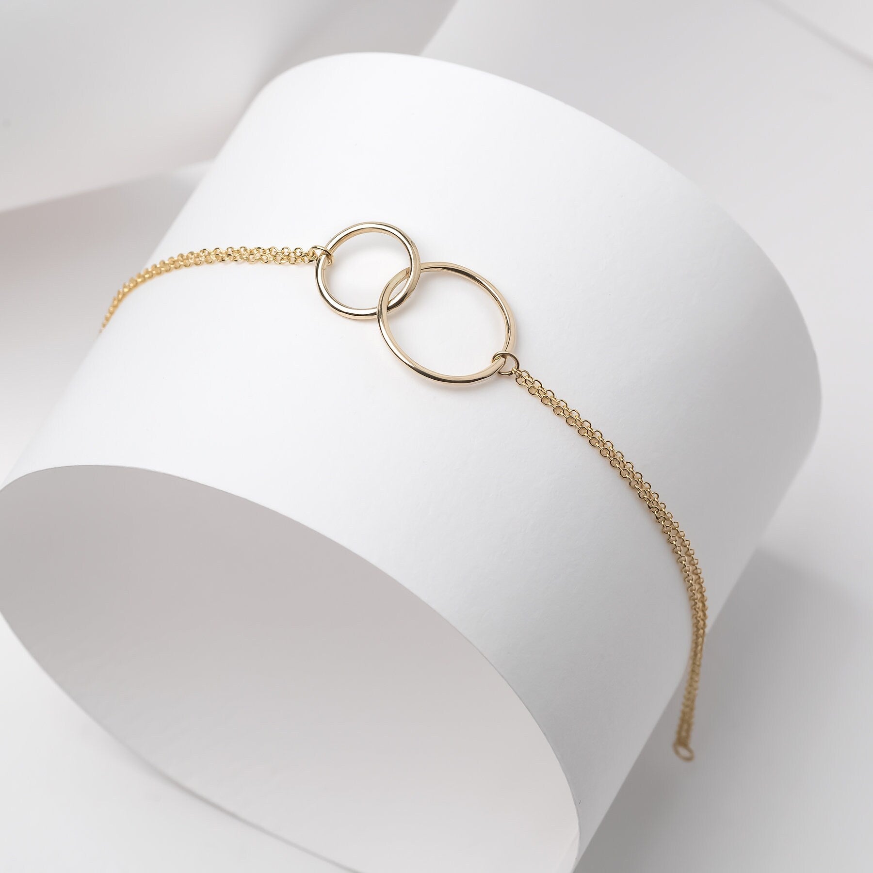 Interlocking bracelet crafted from 14k gold, featuring a double chain design.