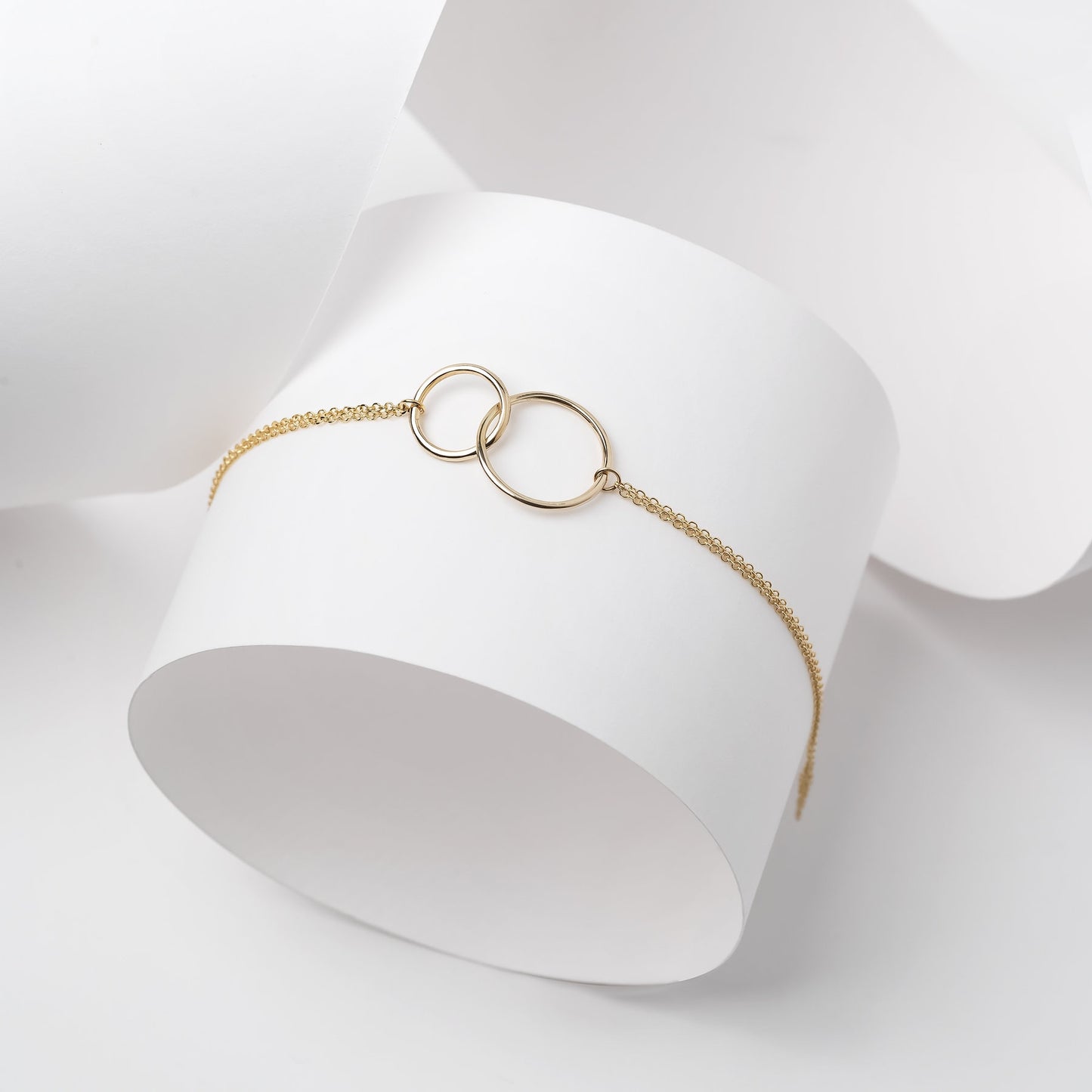 Interlocking bracelet crafted from 14k gold, featuring a double chain design.