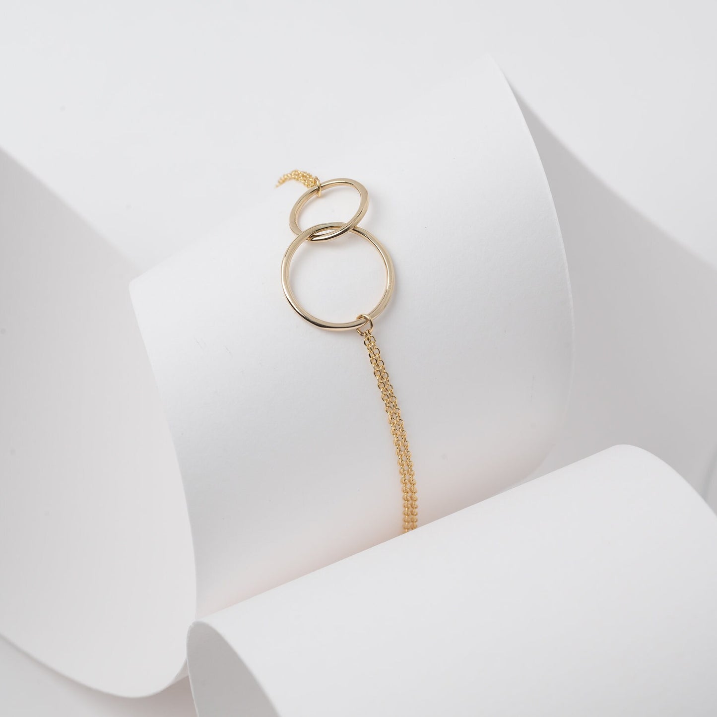 Interlocking bracelet crafted from 14k gold, featuring a double chain design.