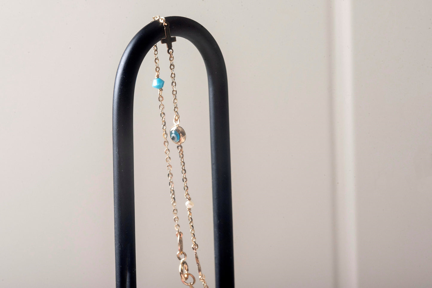 evil eye bracelet with cross, heart, pearl, turqoise stone in 14k solid gold
