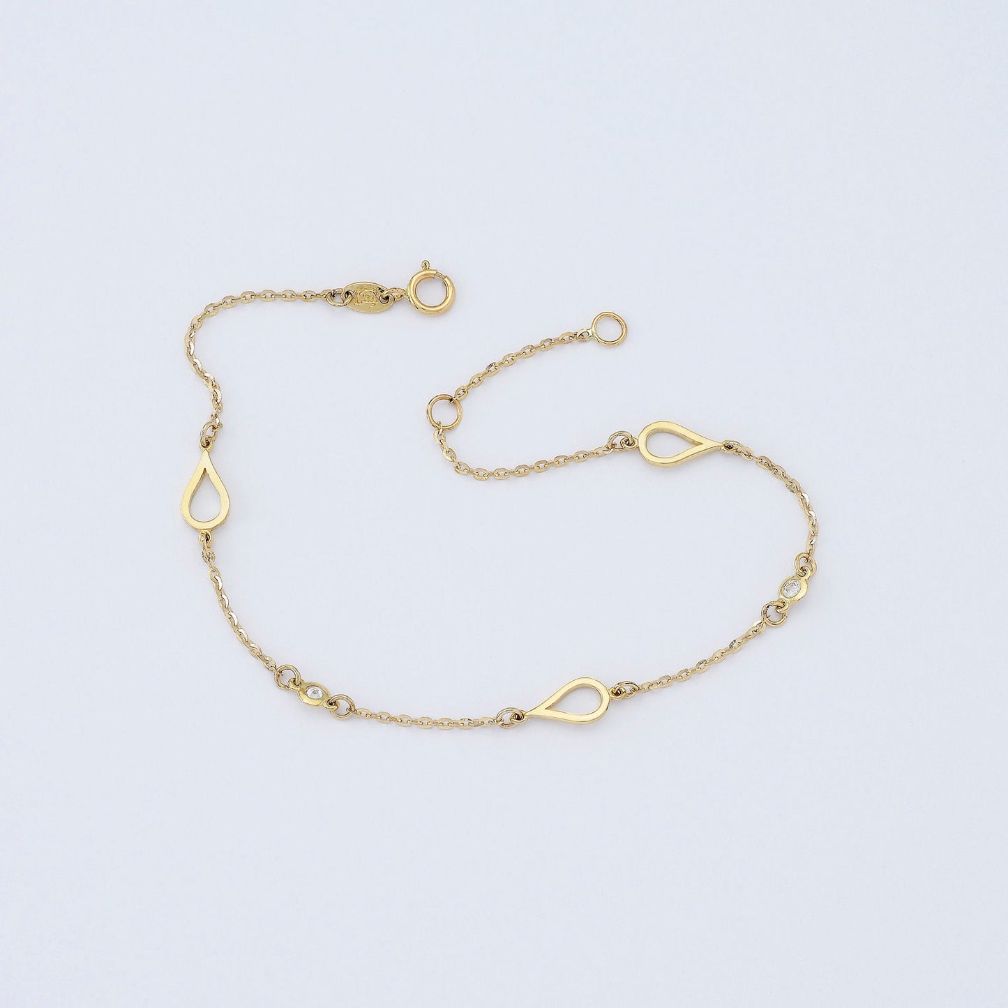 A 14k solid gold bracelet featuring droplets and cubic zirconia stones set in 14k gold.