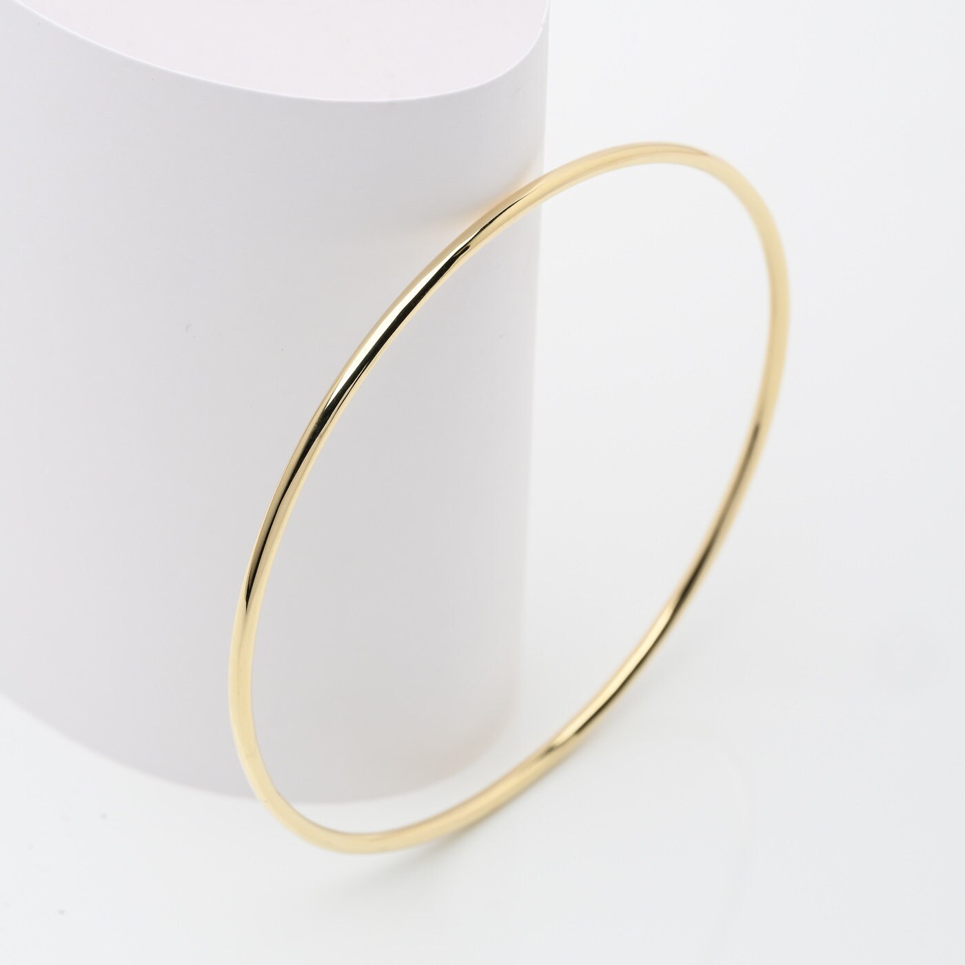 Slip-on 14k solid gold bangle bracelet for women.