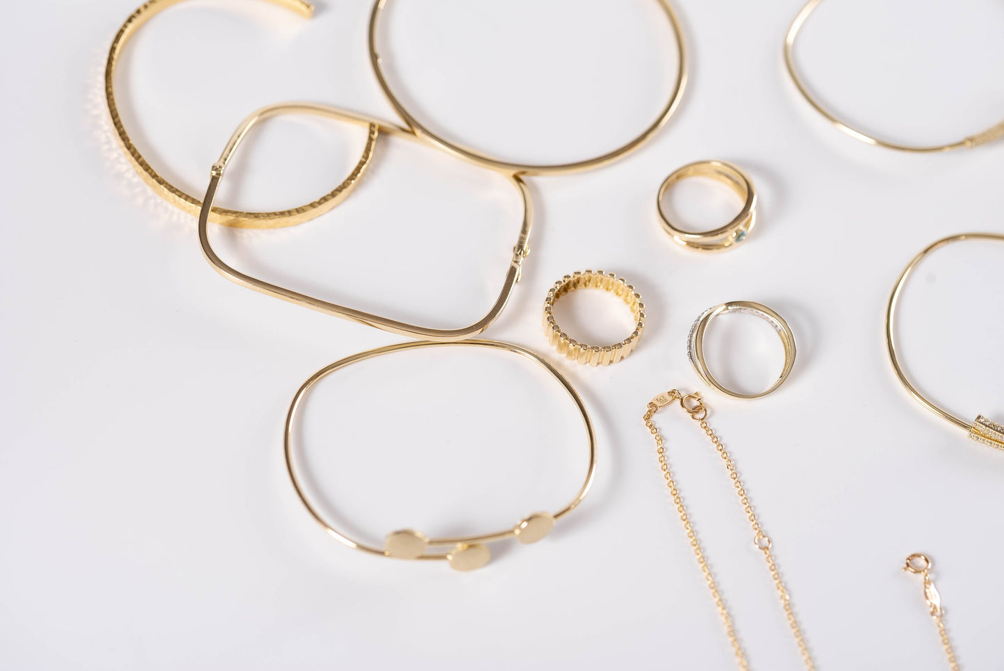 A selection of 14k gold jewelry is showcased by Luna Oro Creations.