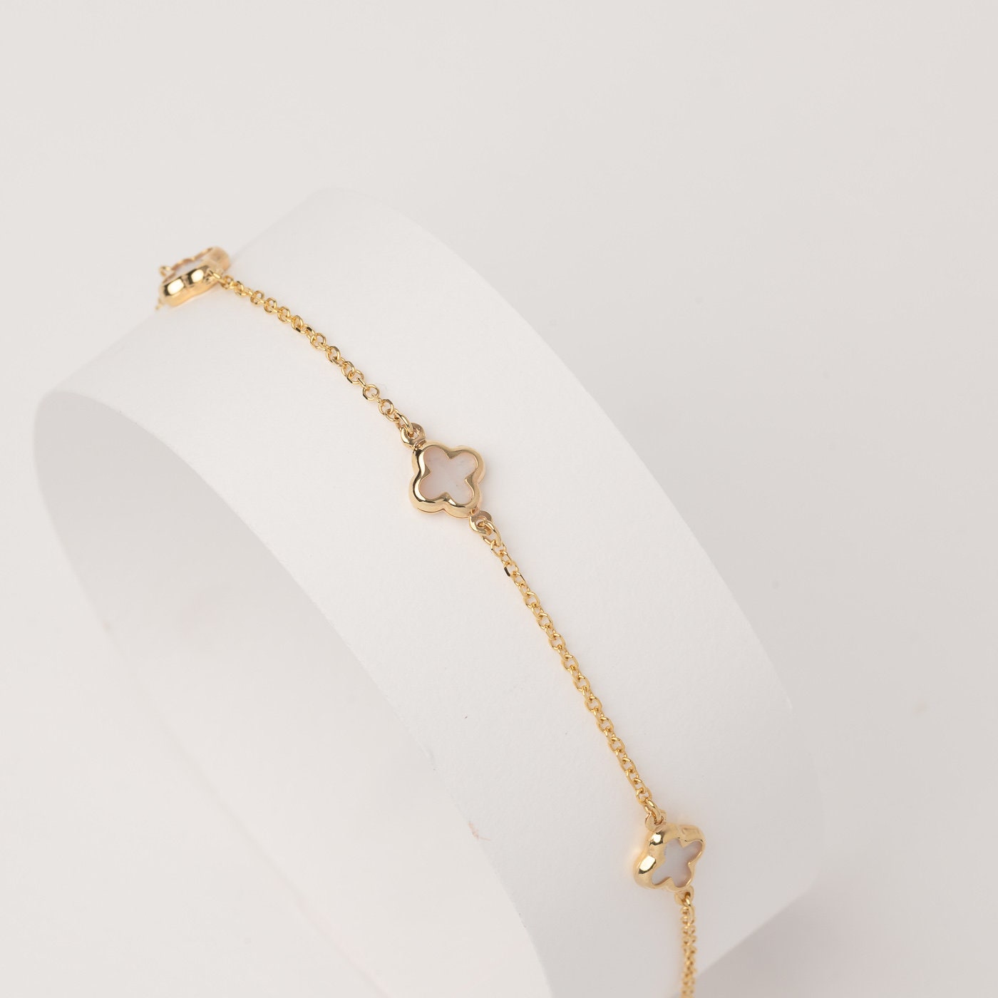 Elegant Mother of Pearl Four-Leaf Clover Bracelet in 14K Gold, Featuring Three Motifs