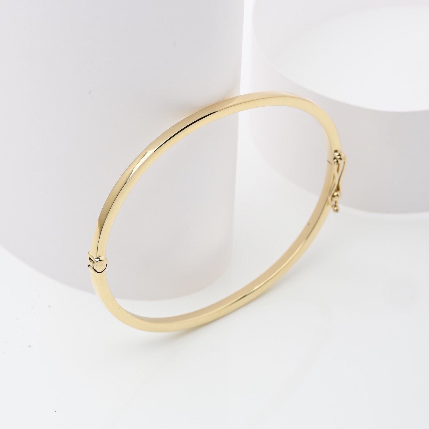 A 2.50mm bangle bracelet crafted in 14k gold, designed for women. 