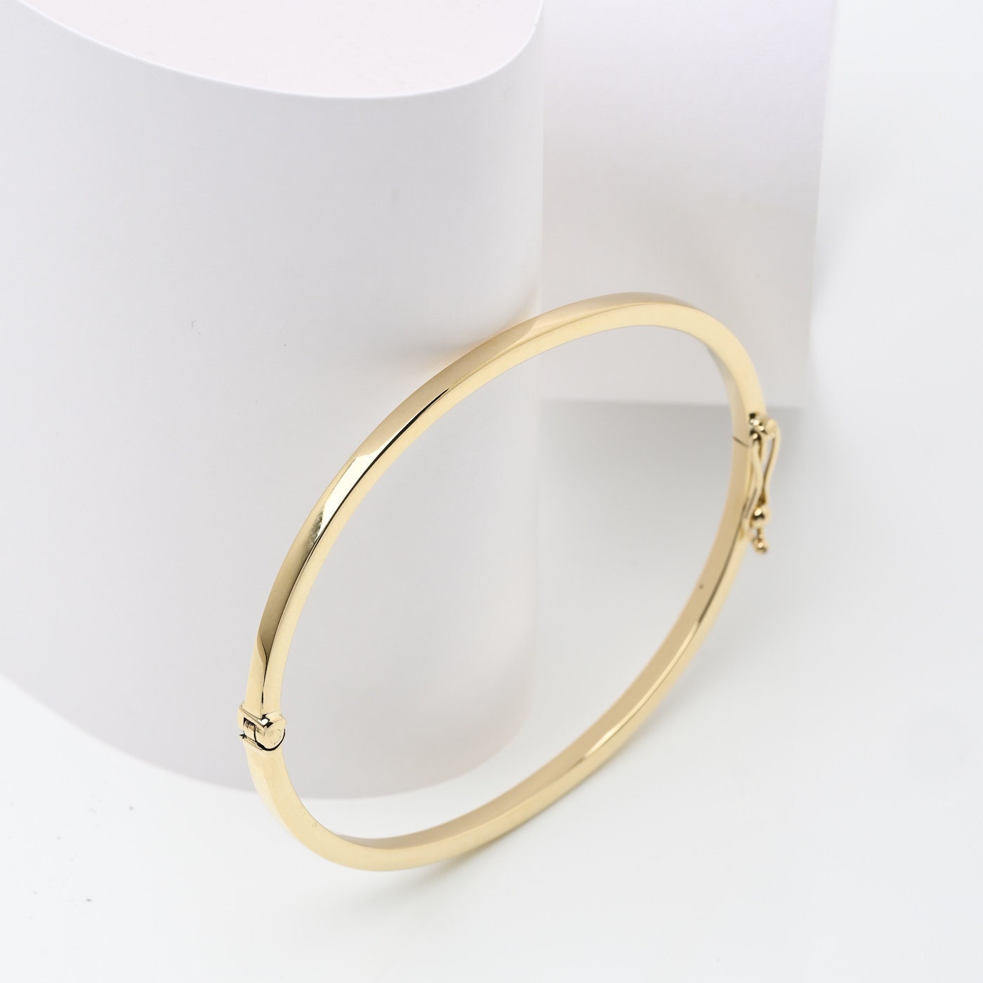 A 2.50mm bangle bracelet crafted in 14k gold, designed for women. 